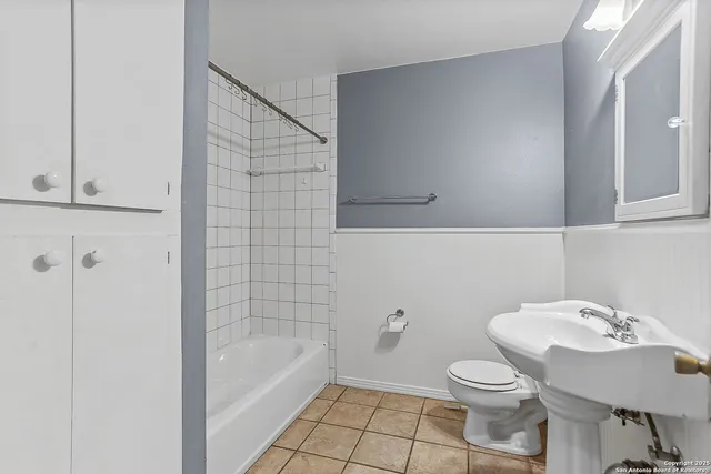 a bathroom with a sink a toilet and bathtub