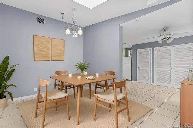 a view of a dining room with furniture and chandelier