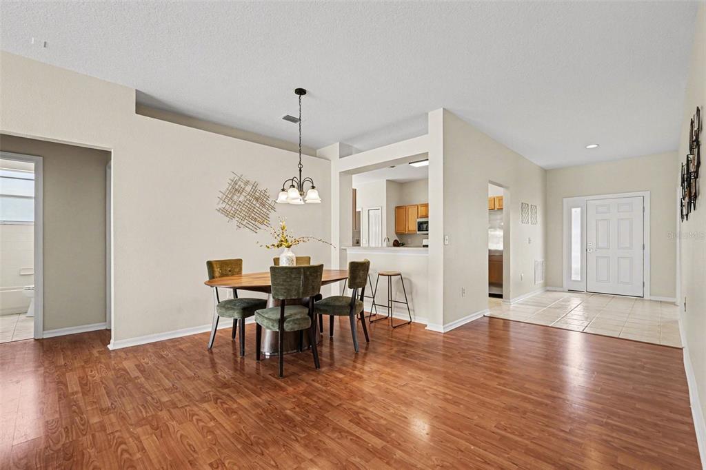 30631 Nickerson Loop Wesley Chapel, FL 33543 - Photo 13 of 33 a view of a dining room with furniture and wooden floor