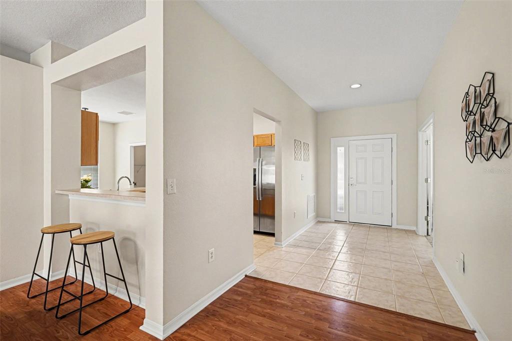 30631 Nickerson Loop Wesley Chapel, FL 33543 - Photo 14 of 33 a view of a hallway with wooden floor and a bathroom