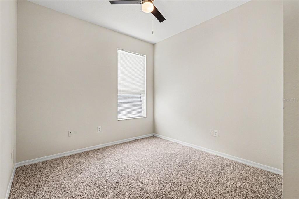 30631 Nickerson Loop Wesley Chapel, FL 33543 - Photo 24 of 33 an empty room with a ceiling fan and a window