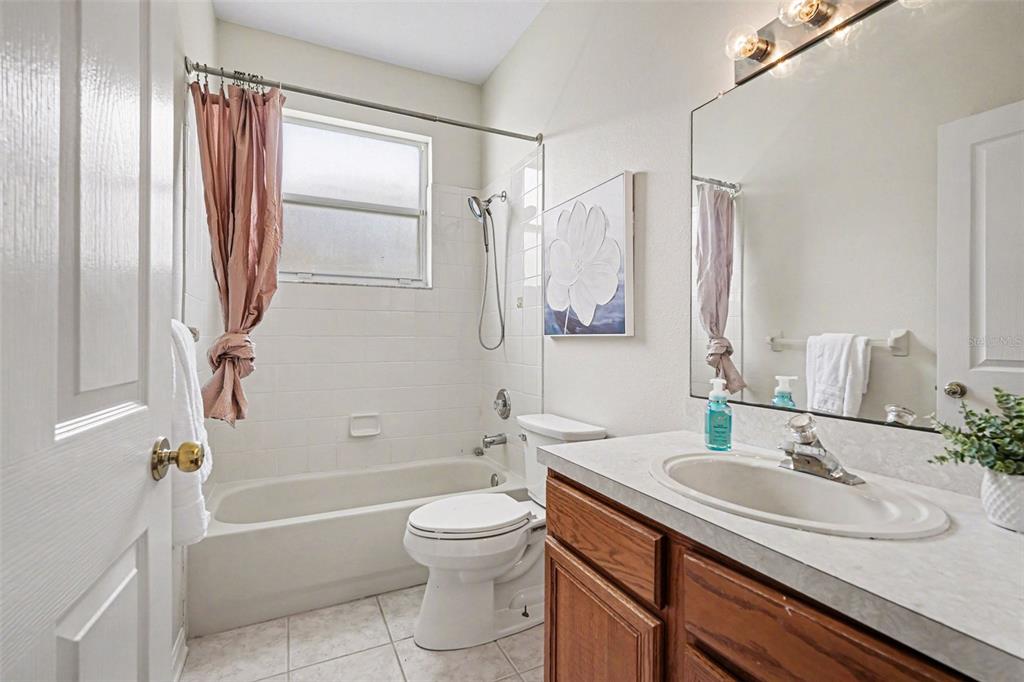 30631 Nickerson Loop Wesley Chapel, FL 33543 - Photo 27 of 33 a bathroom with a granite countertop sink toilet and shower
