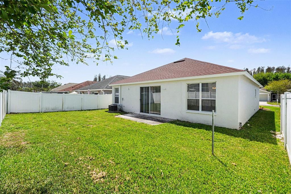 30631 Nickerson Loop Wesley Chapel, FL 33543 - Photo 31 of 33 a house with a tree in front of it