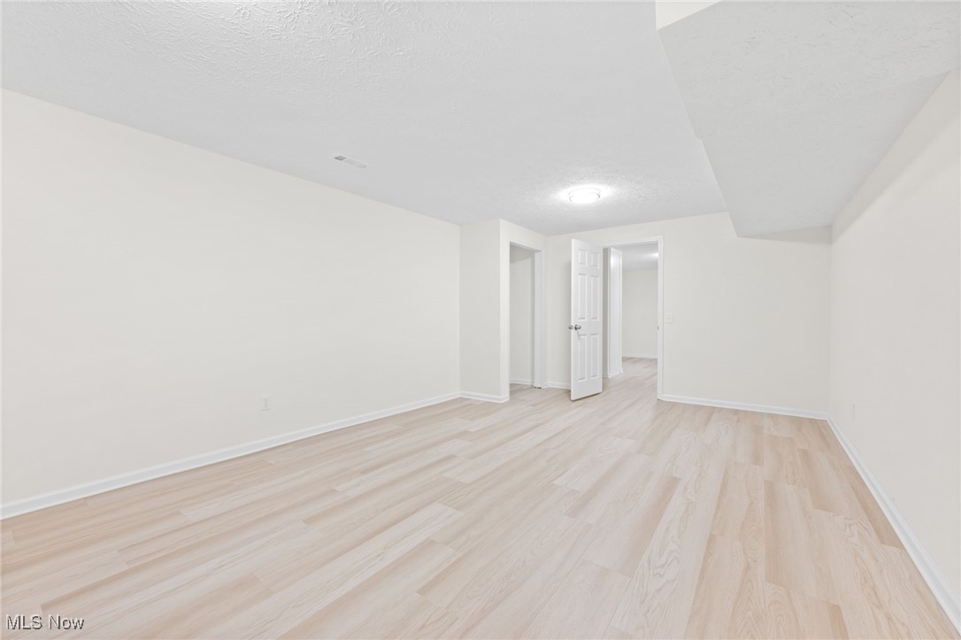4098 State Road Medina, OH 44256 - Photo 25 of 41 Unfurnished room featuring a textured ceiling and light wood-type flooring