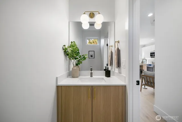 a bathroom with a sink vanity and a mirror
