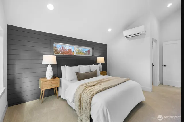 a bedroom with a bed and a wall painting