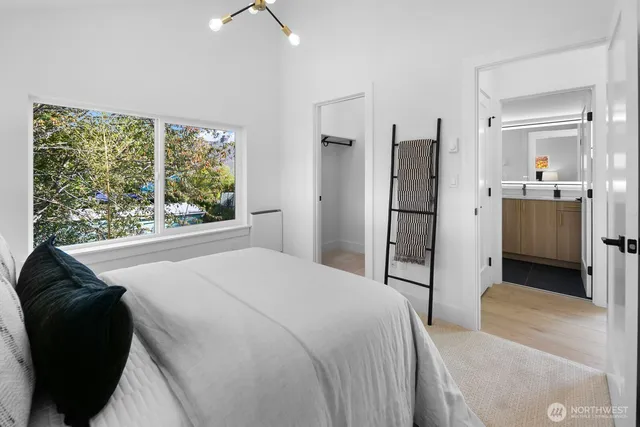 a spacious bedroom with a bed and a large window