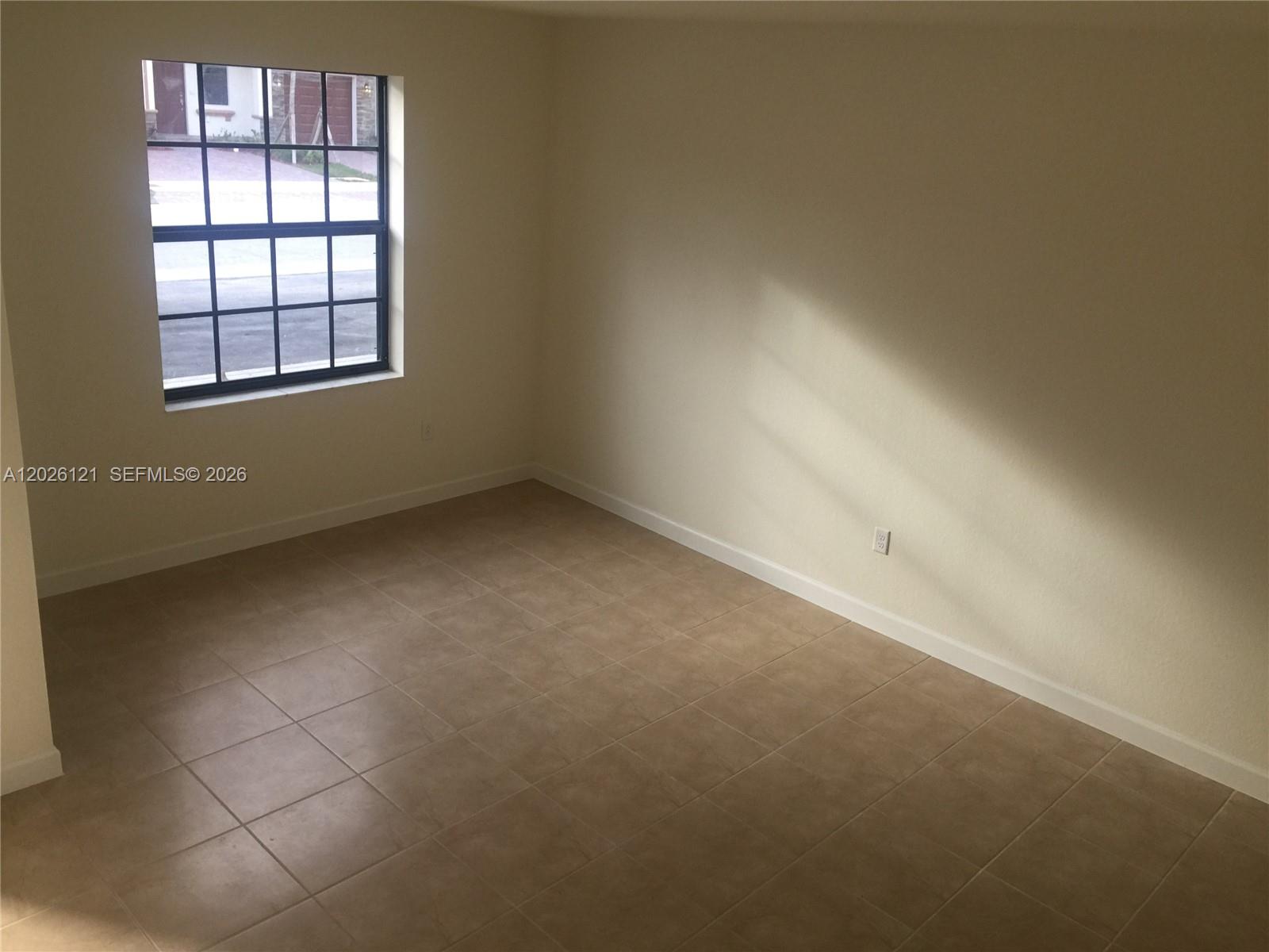 9307 West 33rd Way Hialeah, FL 33018 - Photo 4 of 23 an empty room with a empty space and windows