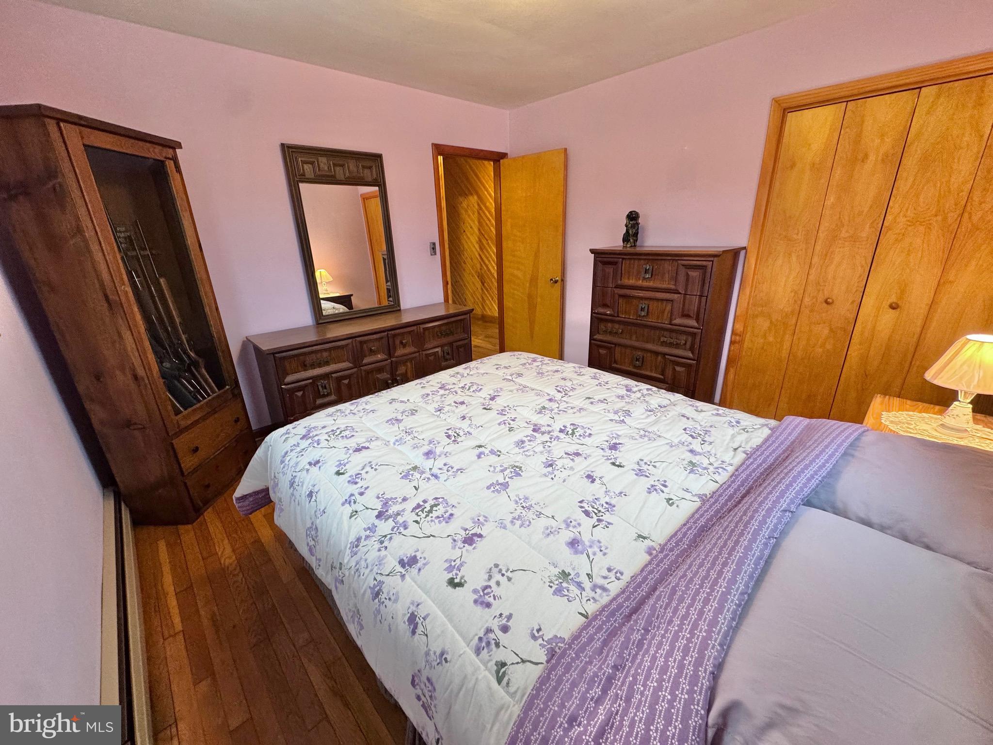 115 Upper Gyp Road Bellefonte, PA 16823 - Photo 11 of 27 a bedroom with a bed and wooden floor