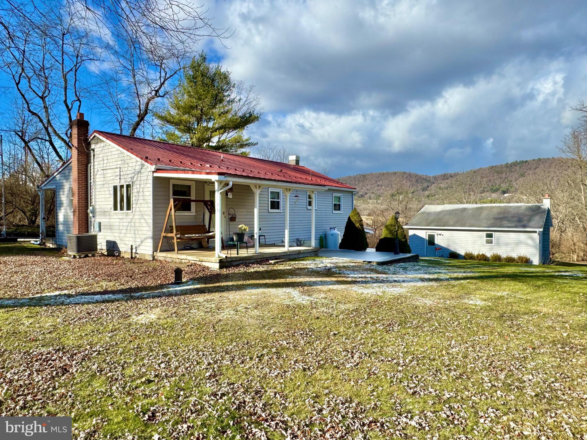 115 Upper Gyp Road Bellefonte, PA 16823 - Photo 20 of 27 a view of a house with a swimming pool and a yard