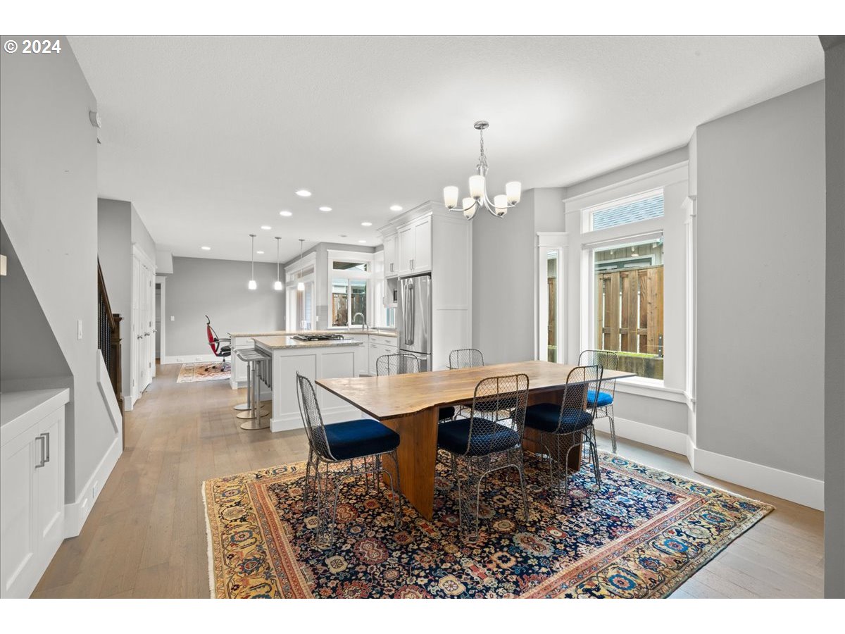 625 3rd Street Lake Oswego, OR 97034 - Photo 13 of 43 a dining room with wooden floor and chandelier