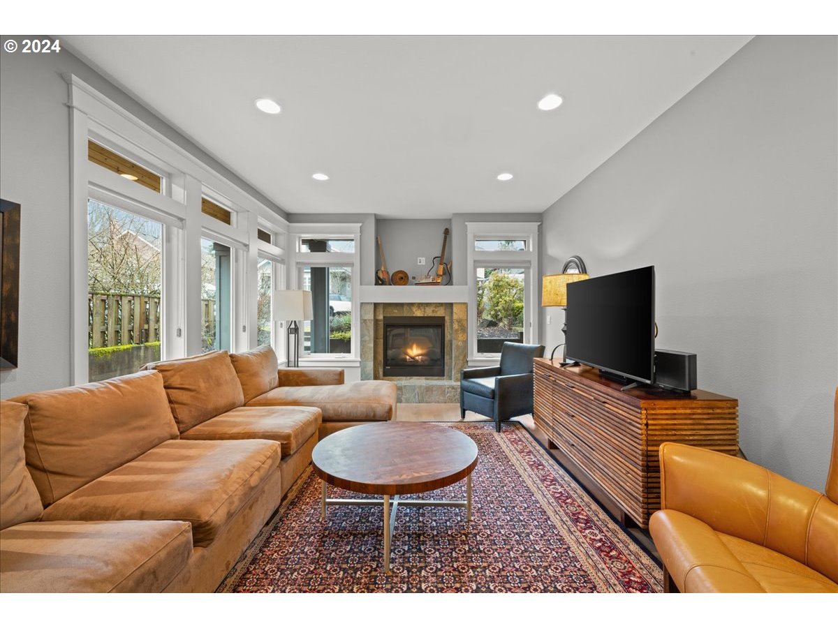 625 3rd Street Lake Oswego, OR 97034 - Photo 8 of 43 a living room with furniture a flat screen tv and a fireplace
