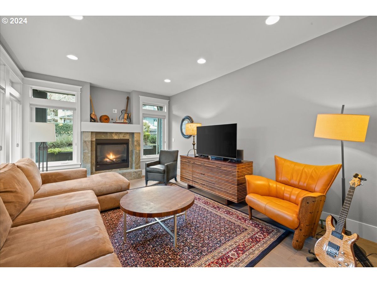 625 3rd Street Lake Oswego, OR 97034 - Photo 10 of 43 a living room with furniture a flat screen tv and a fireplace