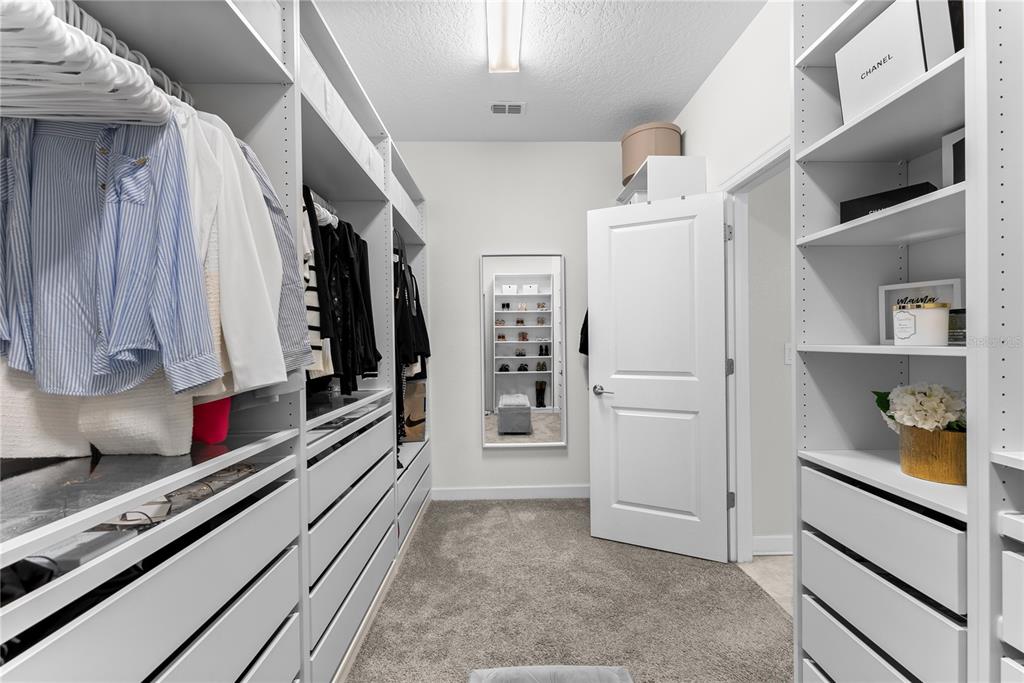 2926 Wordsmith Road Kissimmee, FL 34746 - Photo 31 of 42 a view of walk in closet with clothes and shoes