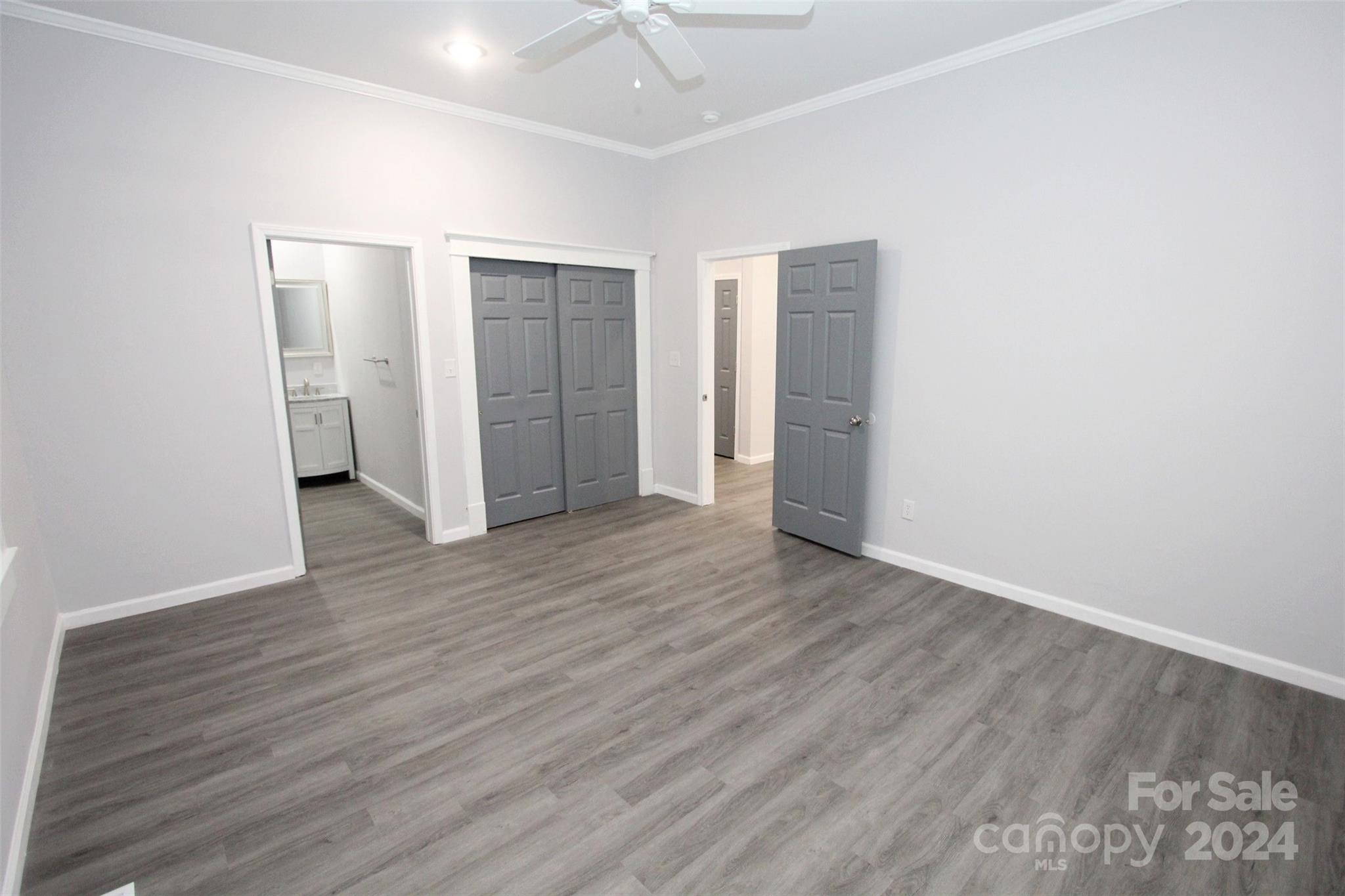 807 East Washington Street Rockingham, NC 28379 - Photo 11 of 42 an empty room with wooden floor and closet