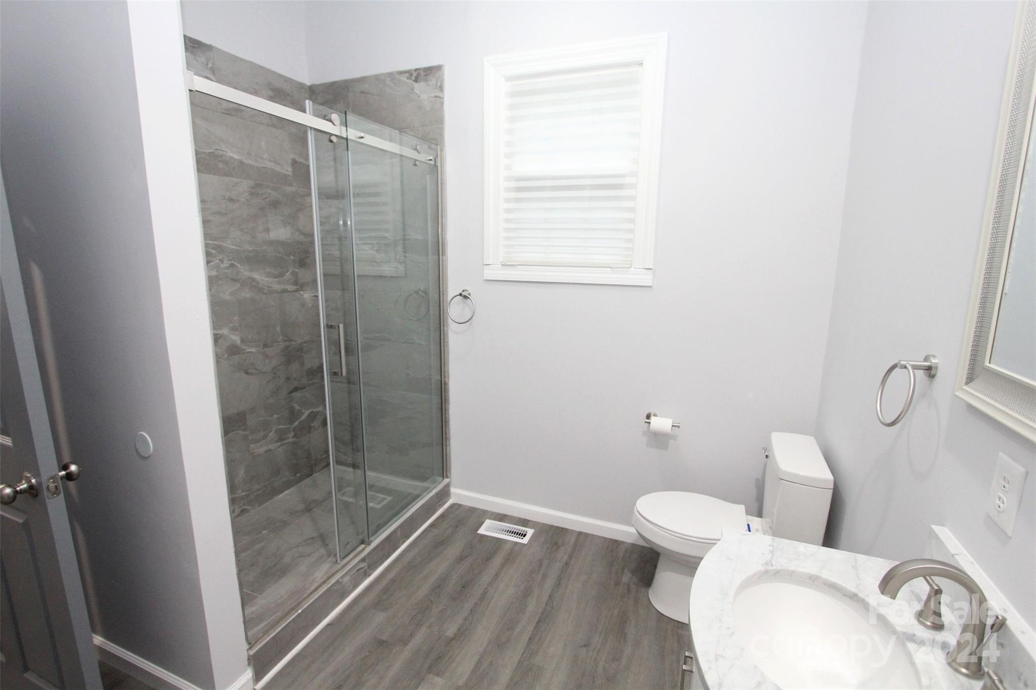 807 East Washington Street Rockingham, NC 28379 - Photo 13 of 42 a bathroom with a toilet and a shower
