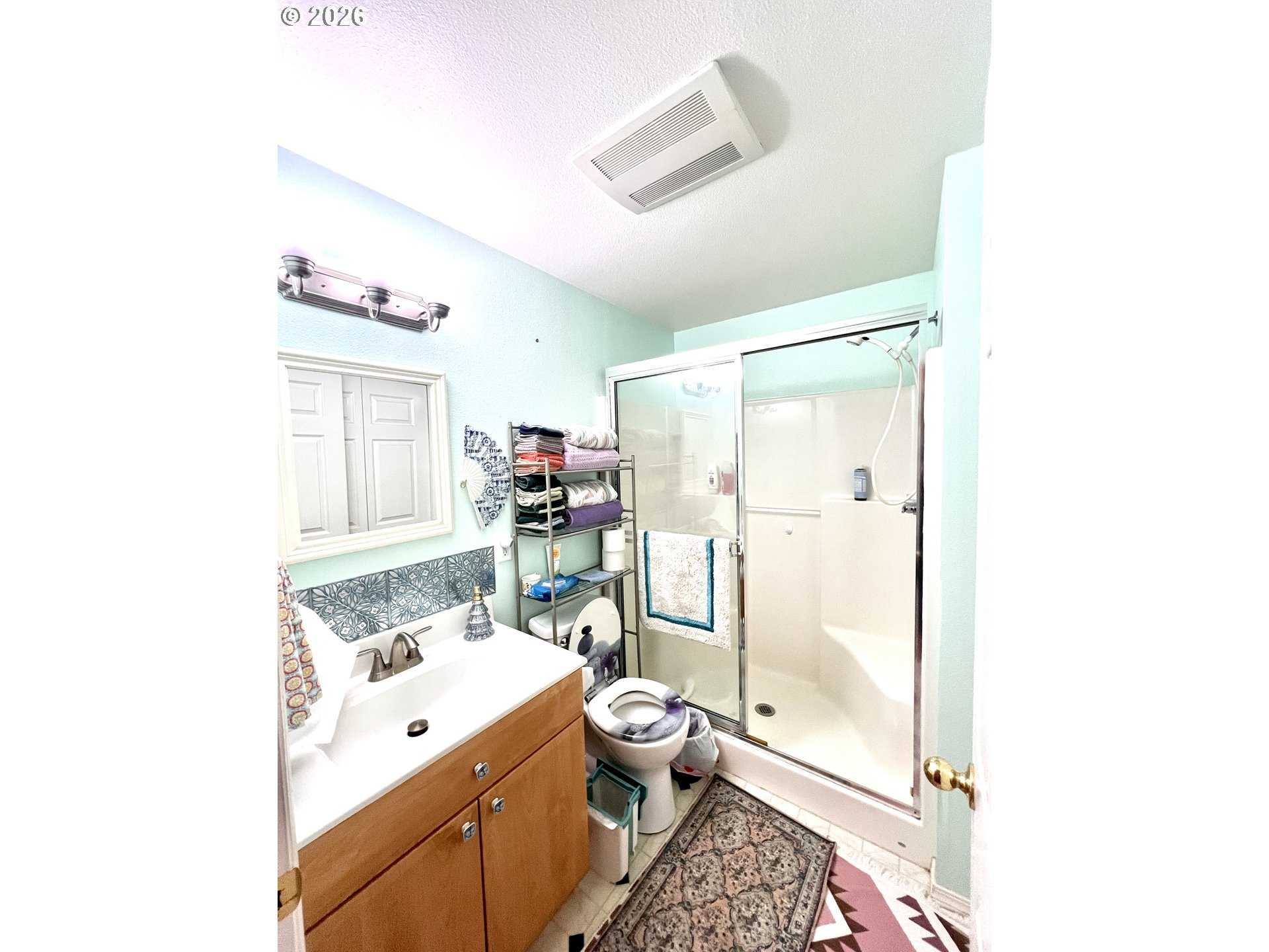 1625 Kristi Loop Lakeside, OR 97449 - Photo 26 of 41 a bathroom with a granite countertop sink a toilet a mirror and shower
