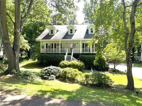a front view of house with yard and green space