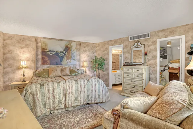 a bedroom with a bed a couch and dresser