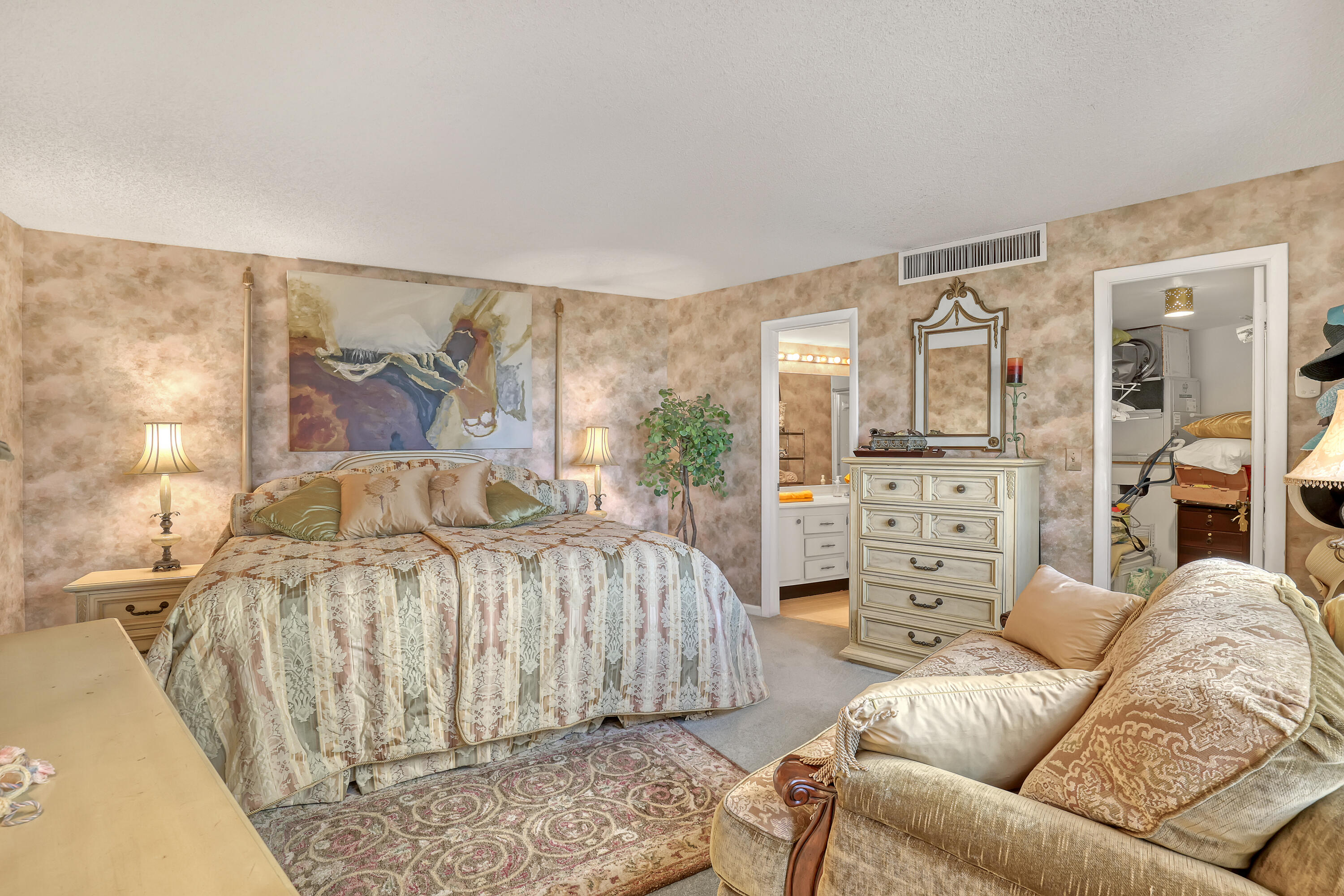 2800 North Ocean Drive, Unit A3C Singer Island, FL 33404 - Photo 11 of 28 a bedroom with a bed a couch and dresser