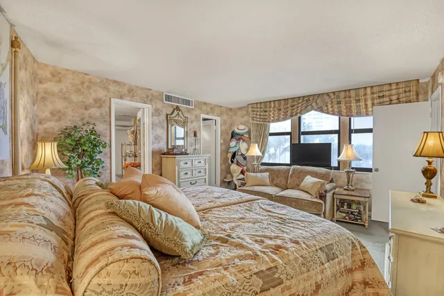 a bedroom with a large bed and a large window