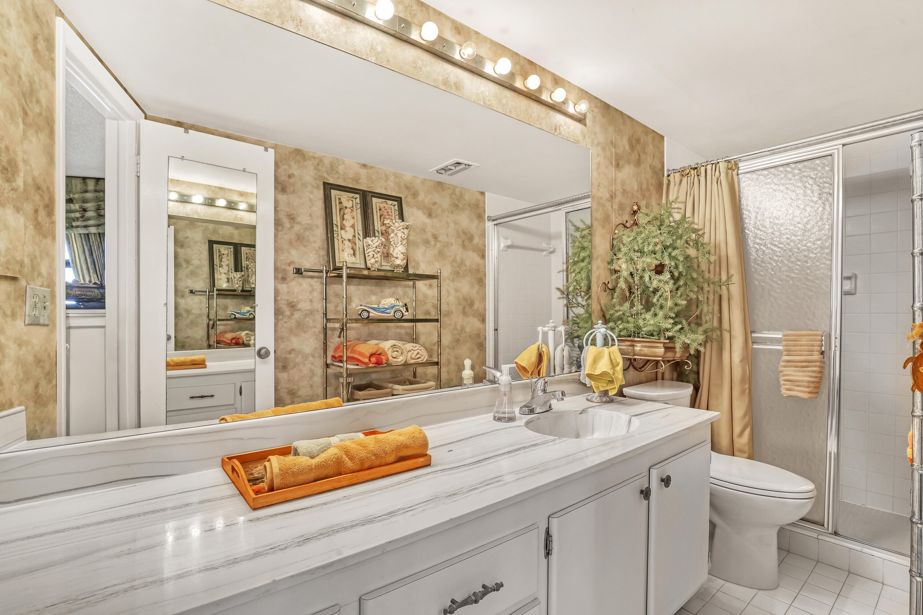 2800 North Ocean Drive, Unit A3C Singer Island, FL 33404 - Photo 15 of 28 a bathroom with a sink and a large mirror