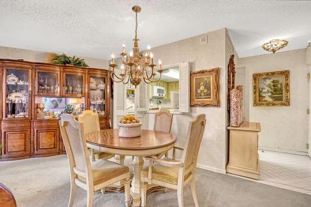 a dining room with furniture and chandelier