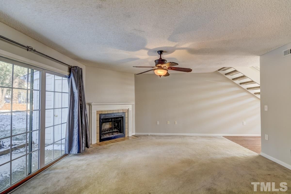7607 Falcon Rest Circle, Unit 7607 Raleigh, NC 27615 - Photo 4 of 12 a view of empty room with fireplace and fan