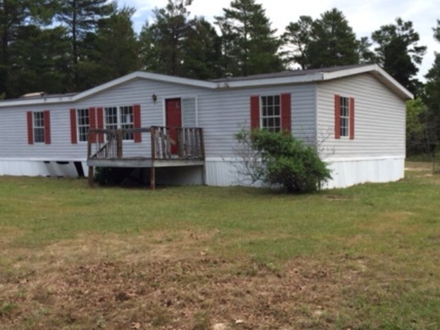 2355 Hortman Mill Road Roberta, GA 31078 - Photo 1 of 9 a front view of a house with a garden