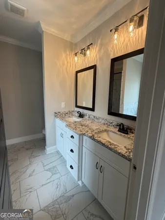 a bathroom with a granite countertop sink and a mirror