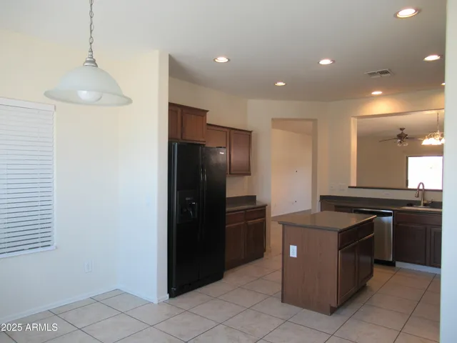 a kitchen with stainless steel appliances granite countertop a refrigerator and a stove