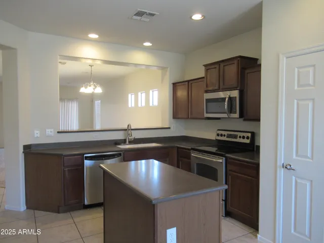 a kitchen with a sink stove and microwave