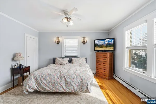 a bedroom with bed and windows