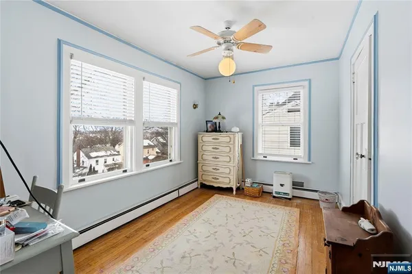 a living room with furniture a window and a dresser