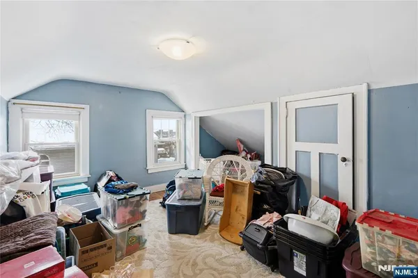 an empty room with windows and closet