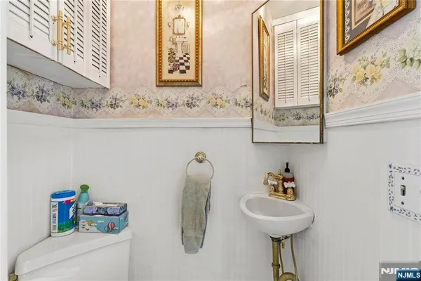 a bathroom with a sink a toilet and mirror