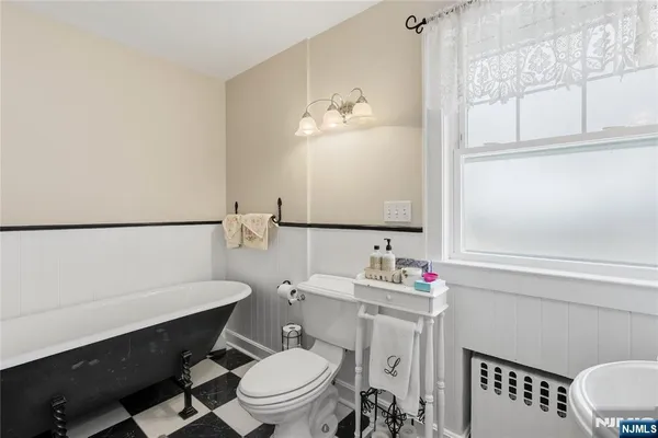a bathroom with a toilet a sink and a mirror