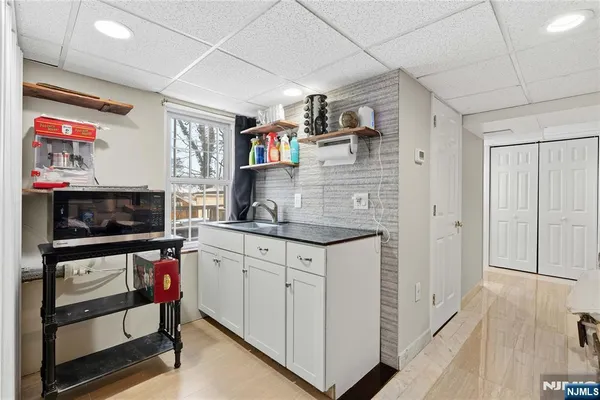 a utility room with fridge dryer and washer