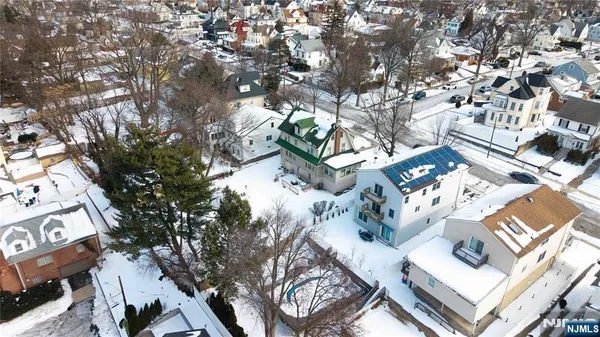 a view of a house with a tree in the background