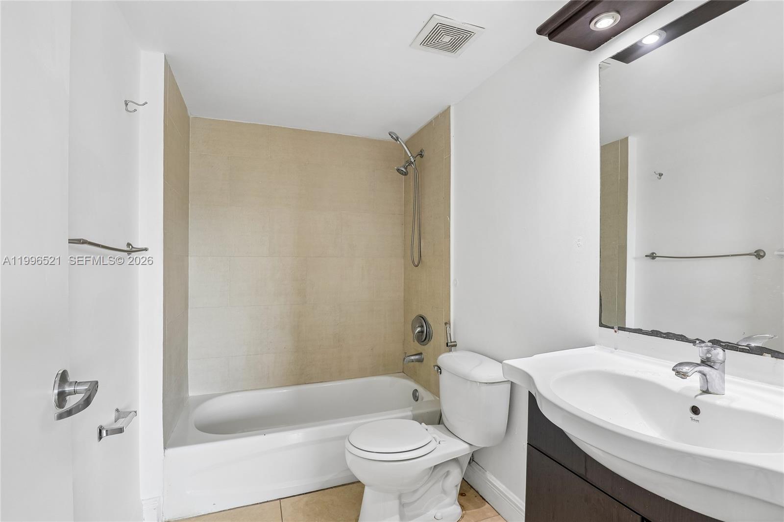 4137 Stirling Road, Unit 507 Dania Beach, FL 33314 - Photo 14 of 20 a bathroom with a sink a toilet and shower