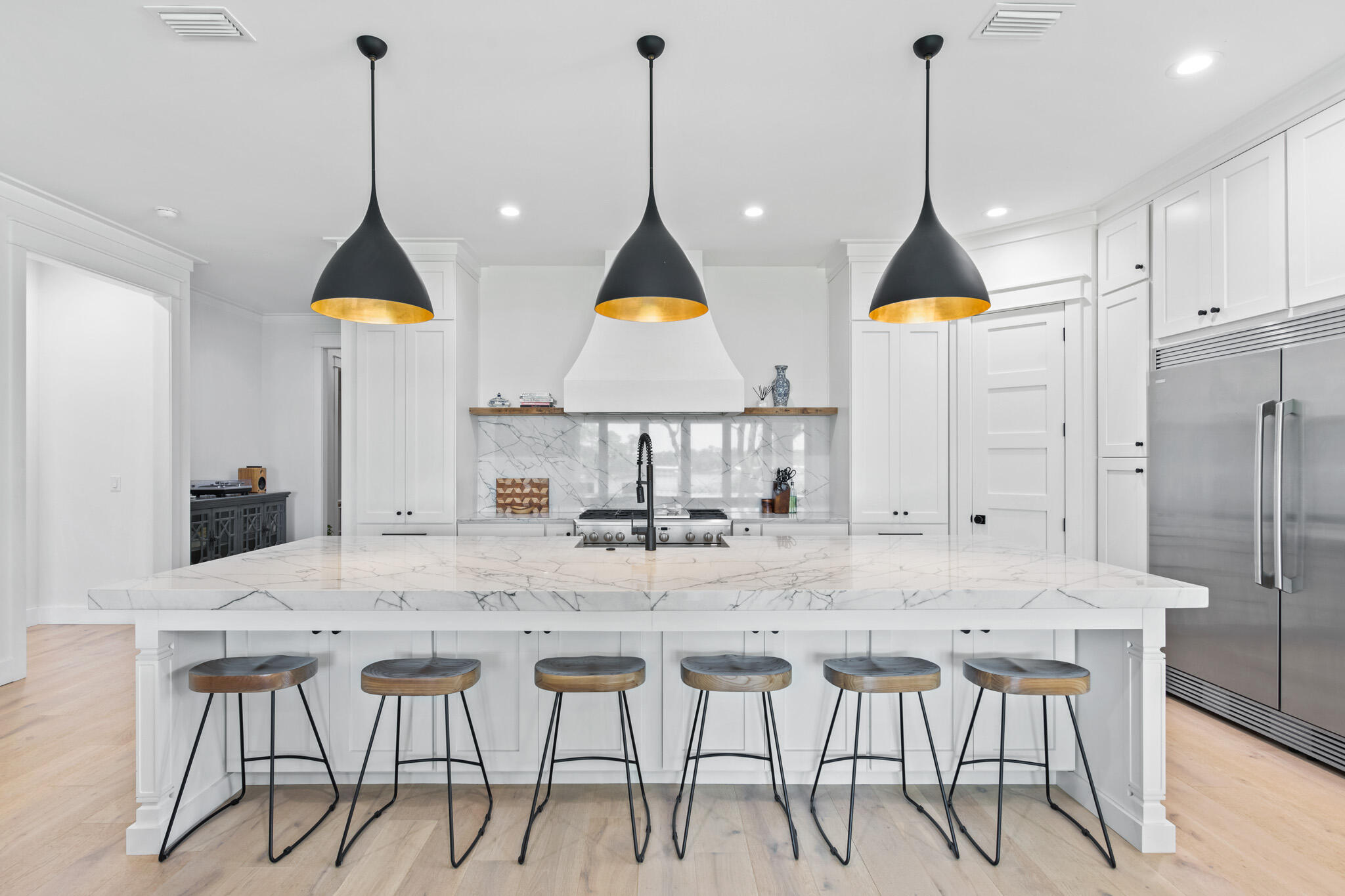 648 Mallet Bayou Road Freeport, FL 32439 - Photo 4 of 86 a kitchen with stainless steel appliances kitchen island granite countertop a table chairs and a wooden floor