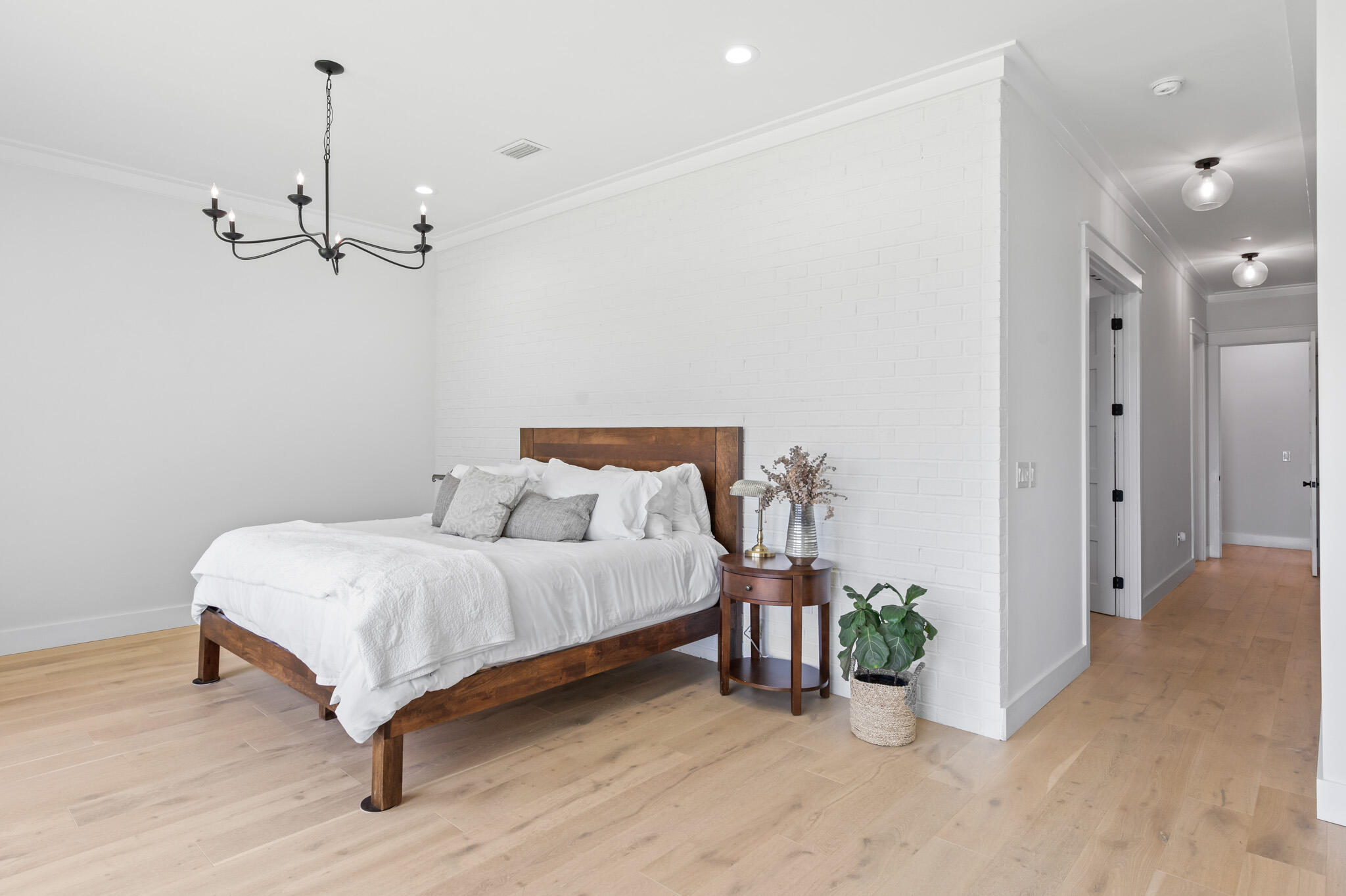 648 Mallet Bayou Road Freeport, FL 32439 - Photo 52 of 86 a spacious bedroom with a bed and a chandelier