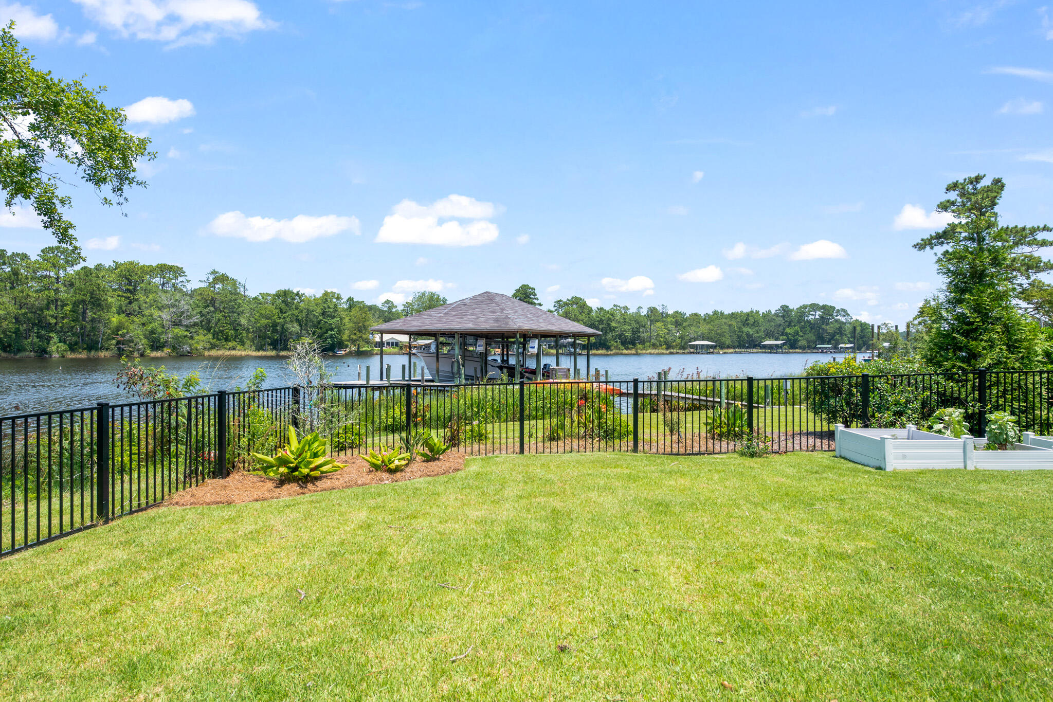 648 Mallet Bayou Road Freeport, FL 32439 - Photo 72 of 86 a view of a house with swimming pool and a yard