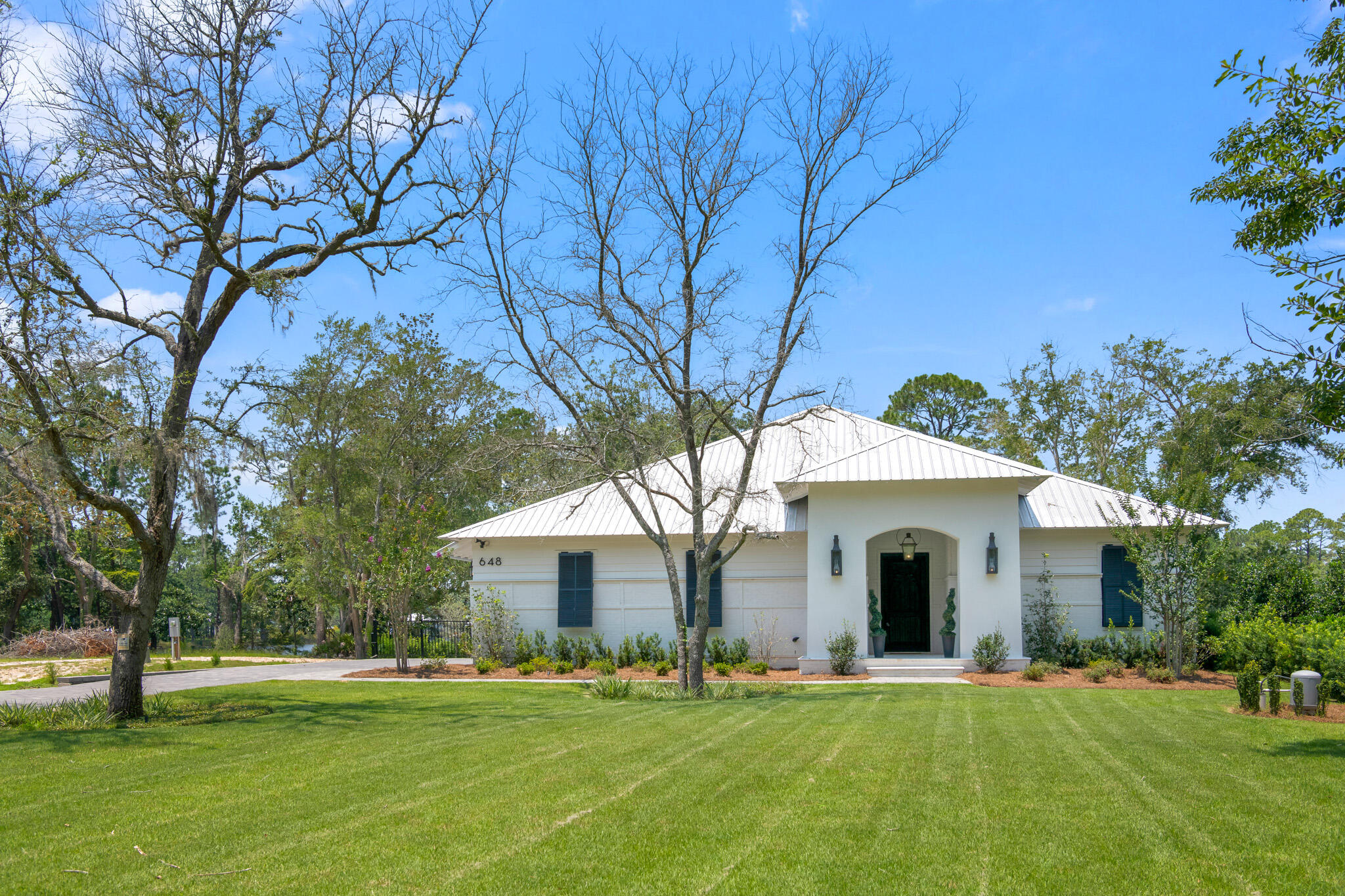 648 Mallet Bayou Road Freeport, FL 32439 - Photo 84 of 86 a white house with a big yard and large trees