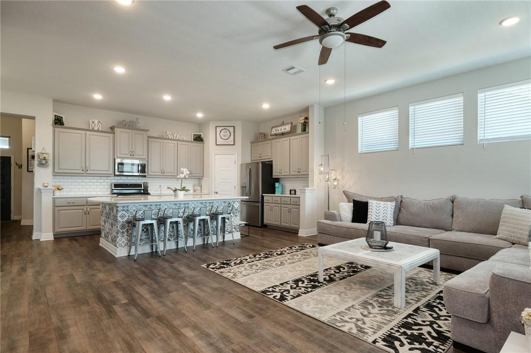 229 Bonnet Boulevard Georgetown, TX 78628 - Photo 3 of 20 Living area featuring recessed lighting, a ceiling fan, dark wood finished floors, and healthy amount of natural light