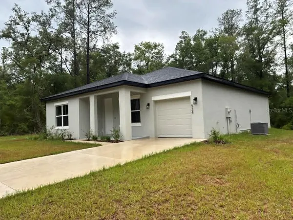a front view of house with yard and trees