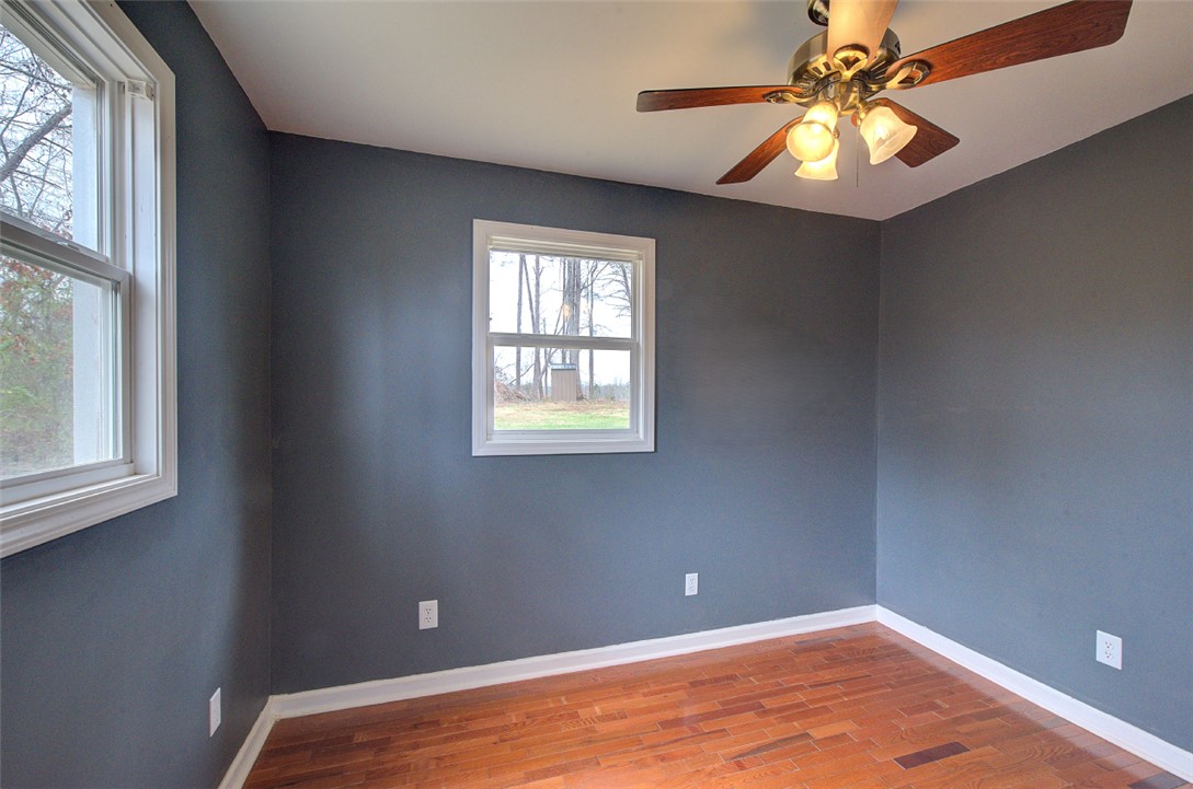 325 Rock Quarry Road Travelers Rest, SC 29690 - Photo 19 of 37 This spacious room features ample natural light and durable flooring, offering a comfortable and adaptable living space.