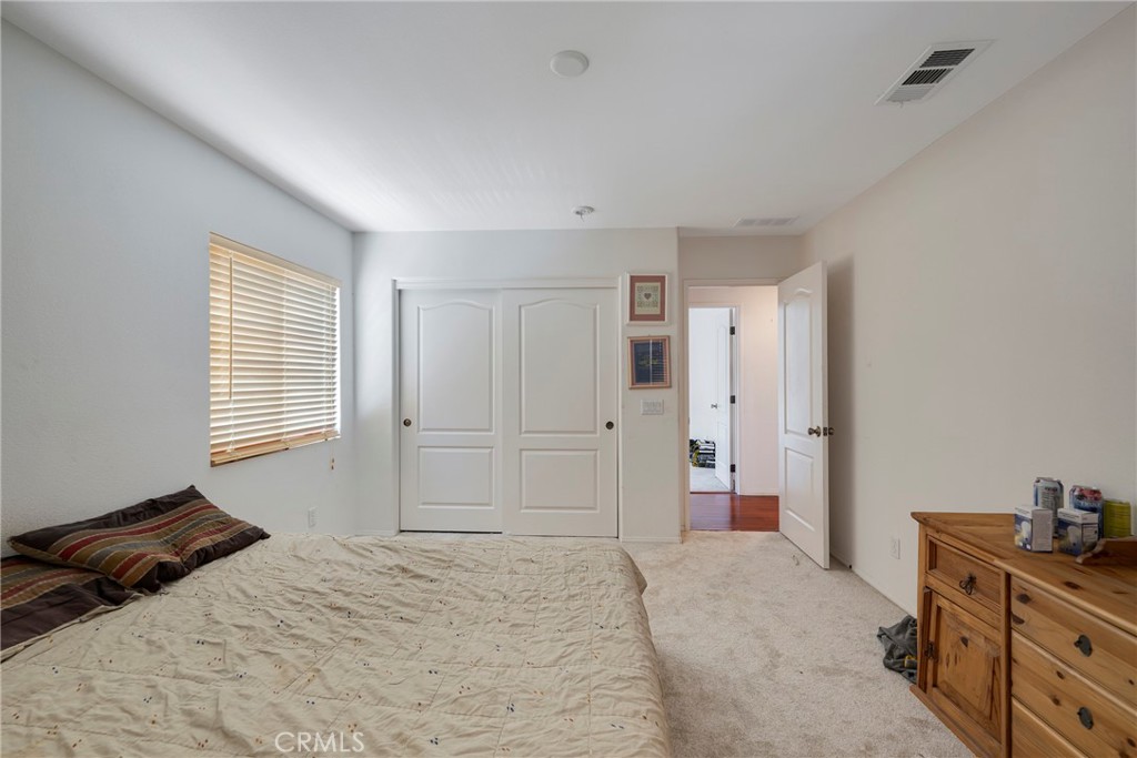 3819 St Austell Way Perris, CA 92571 - Photo 35 of 64 a bedroom with a bed and a dresser