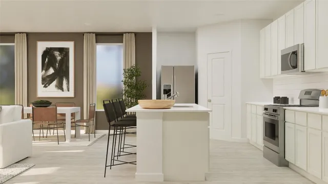 a kitchen with stainless steel appliances kitchen island granite countertop a table and chairs