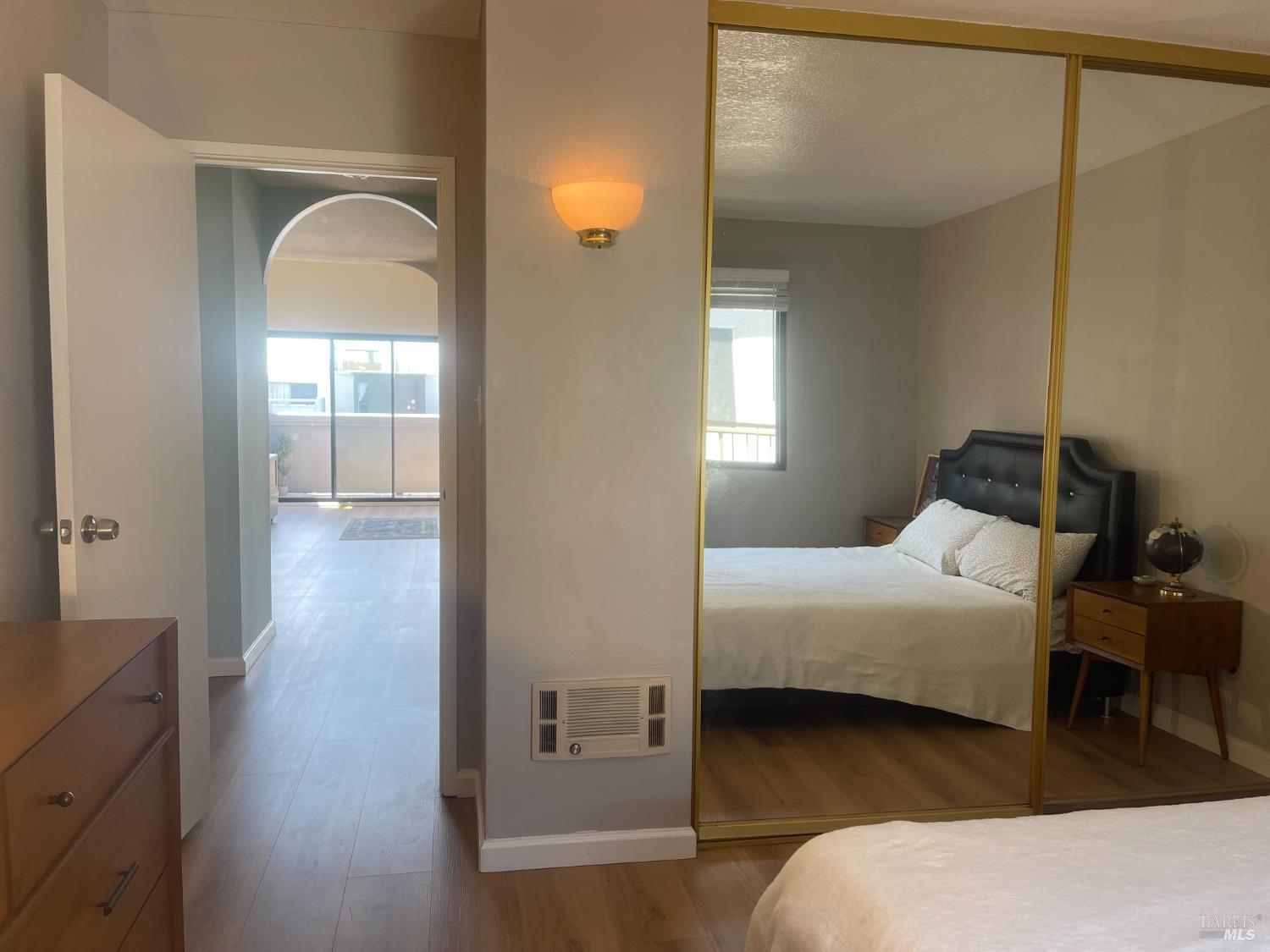 1 Embarcadero West, Unit 355 Oakland, CA 94607 - Photo 15 of 20 a bedroom with a bed and a mirror